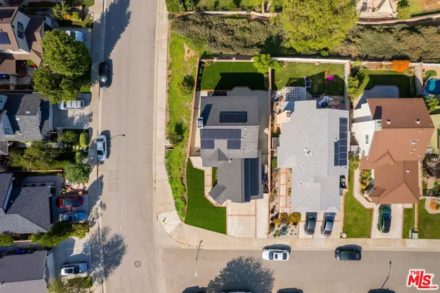 an aerial view of residential houses with outdoor space