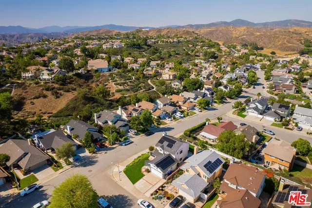 an aerial view of residential houses with city view