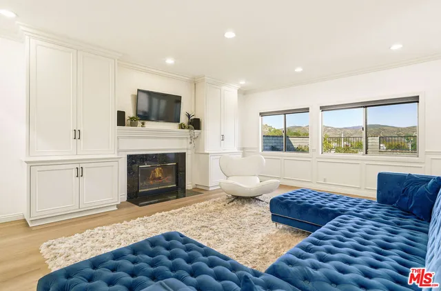 a living room with furniture fireplace and window