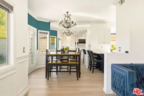a view of a dining room with furniture and chandelier