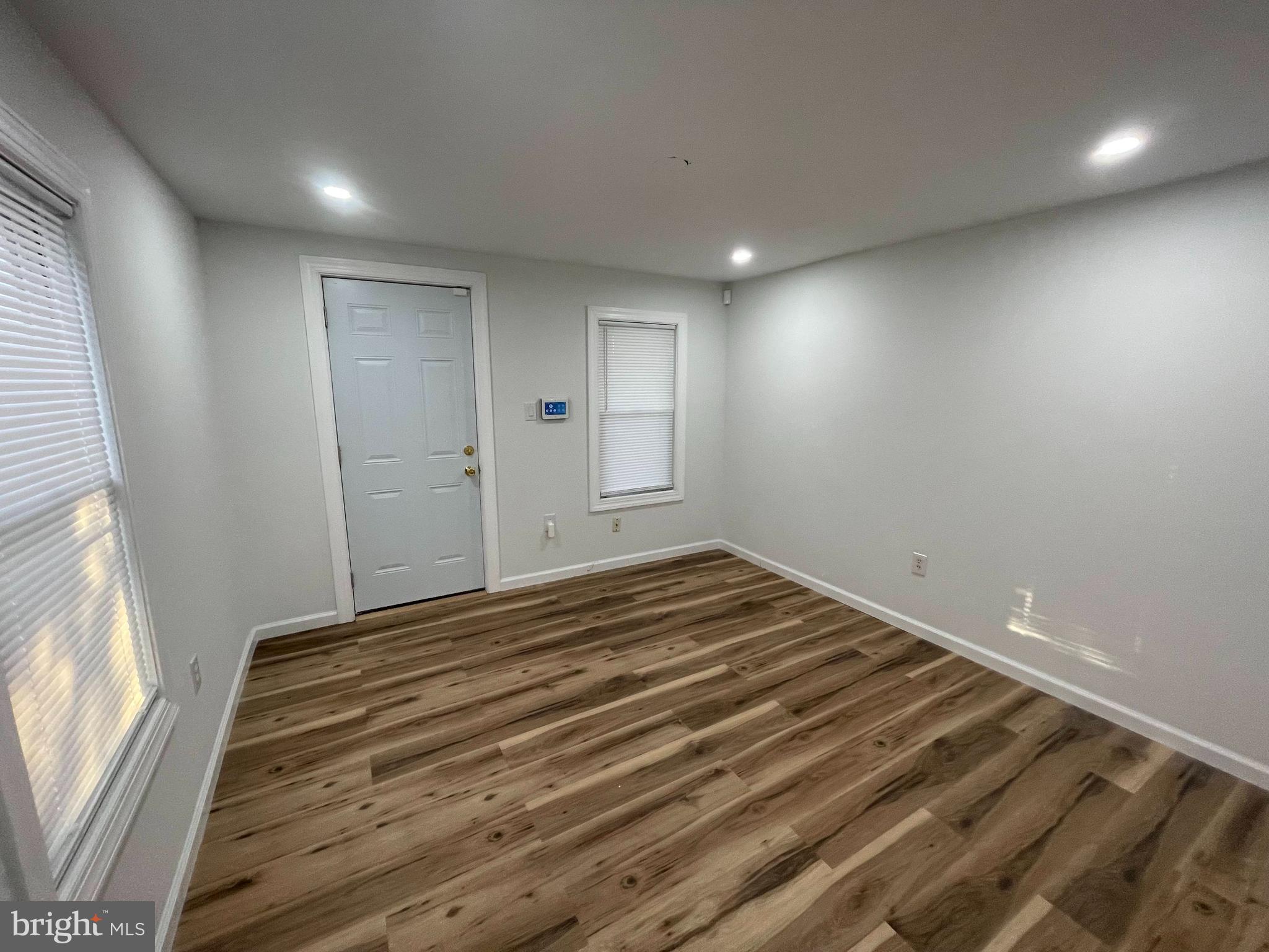 628-630 High Street Cambridge, MD 21613 - Photo 2 of 16 a view of empty room with wooden floor and fan