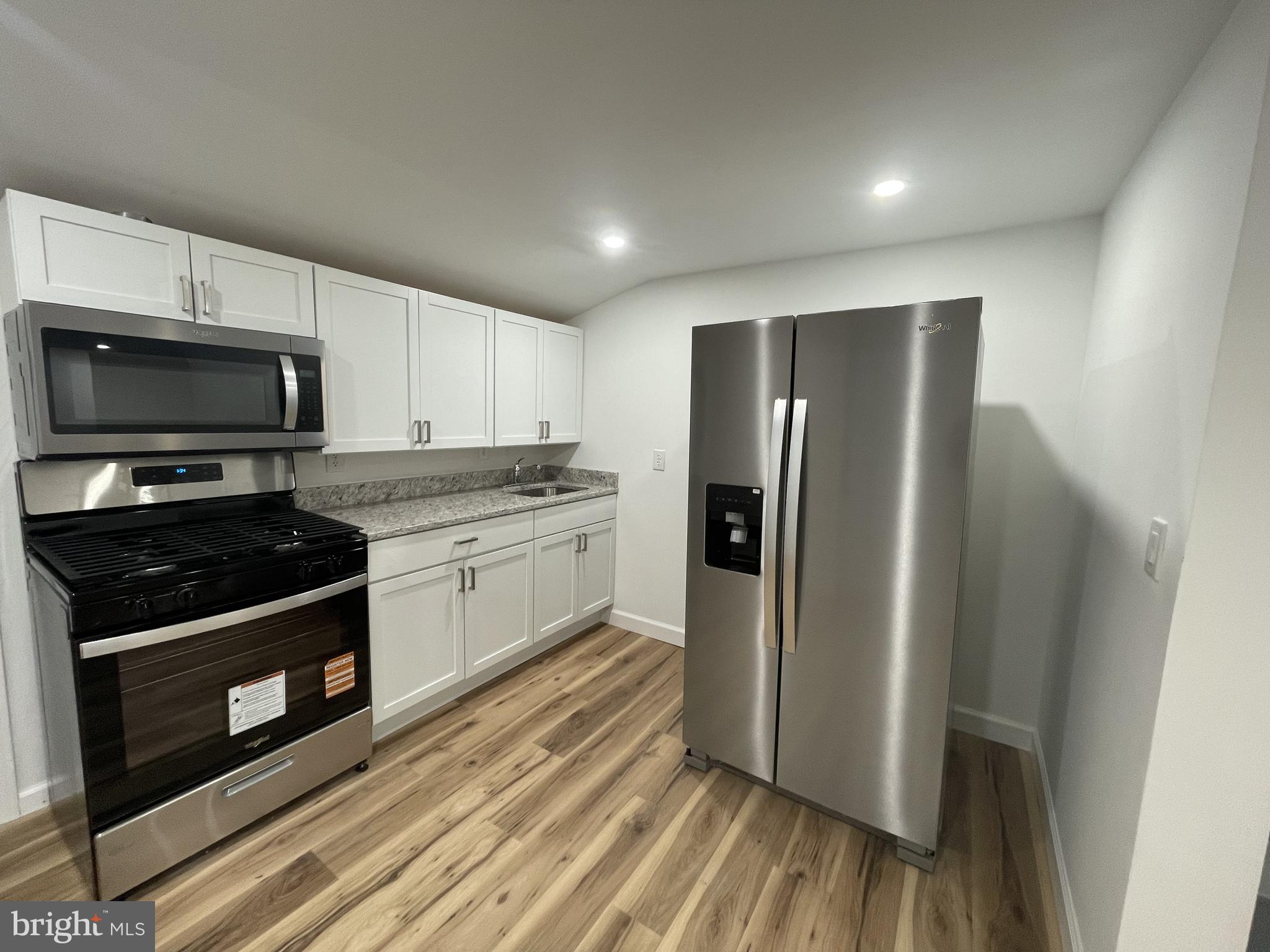 628-630 High Street Cambridge, MD 21613 - Photo 5 of 16 a kitchen with a refrigerator stove and microwave