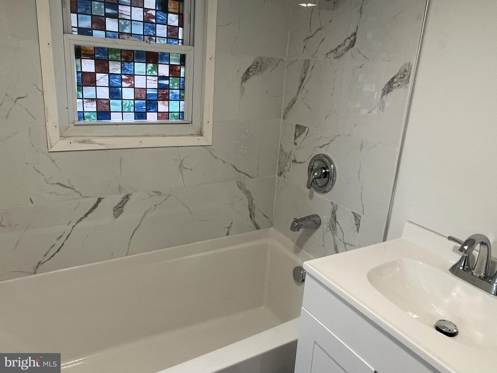 628-630 High Street Cambridge, MD 21613 - Photo 7 of 16 a bathroom with a sink and a bathtub