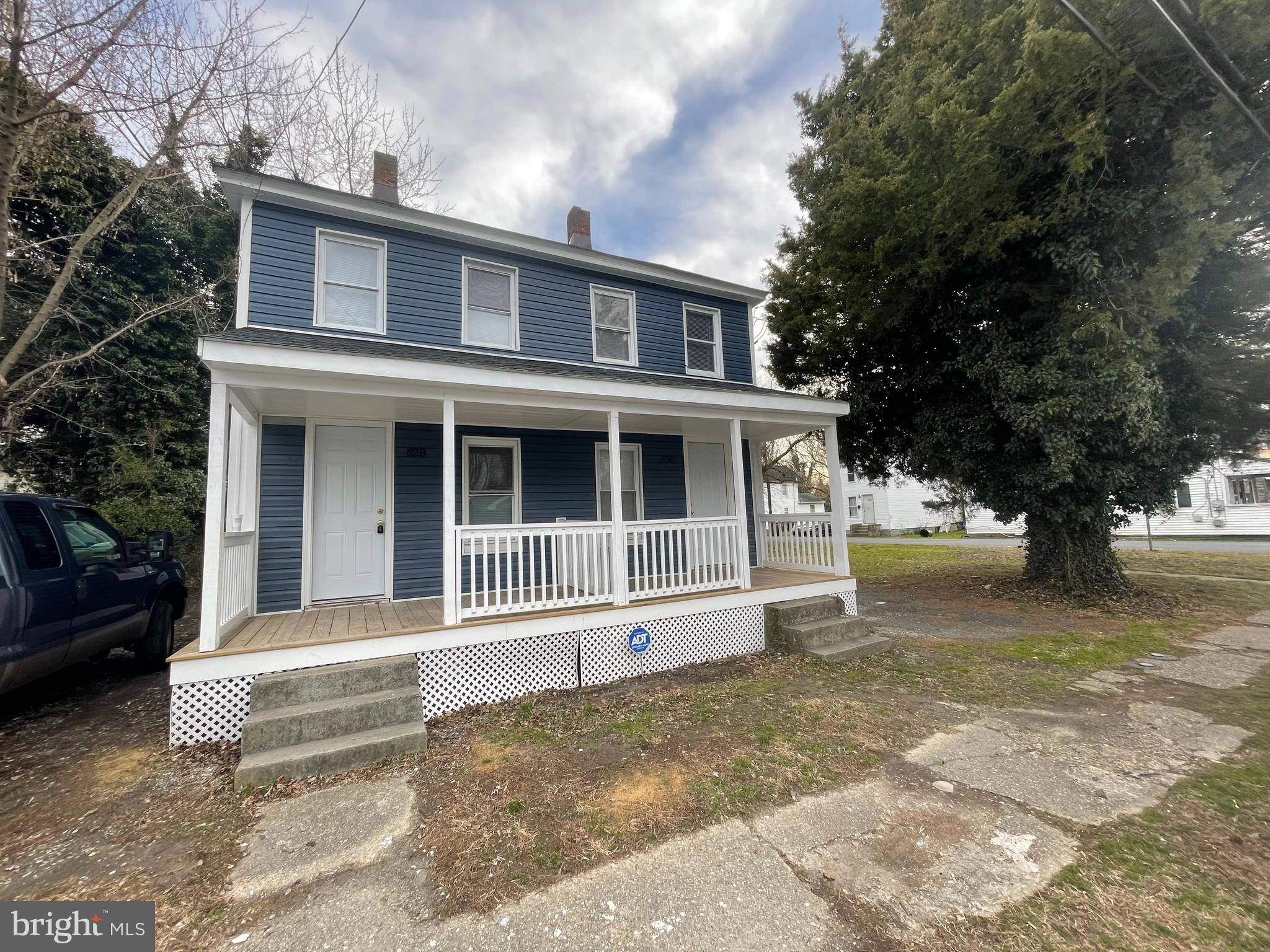628-630 High Street Cambridge, MD 21613 - Photo 10 of 16 a house with trees in front of it