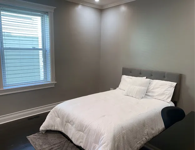 a bedroom with a bed and window