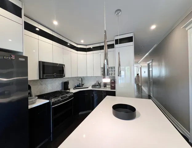 a kitchen with a sink stainless steel appliances and cabinets