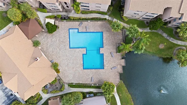 an aerial view of a house with a yard basket ball court and outdoor seating