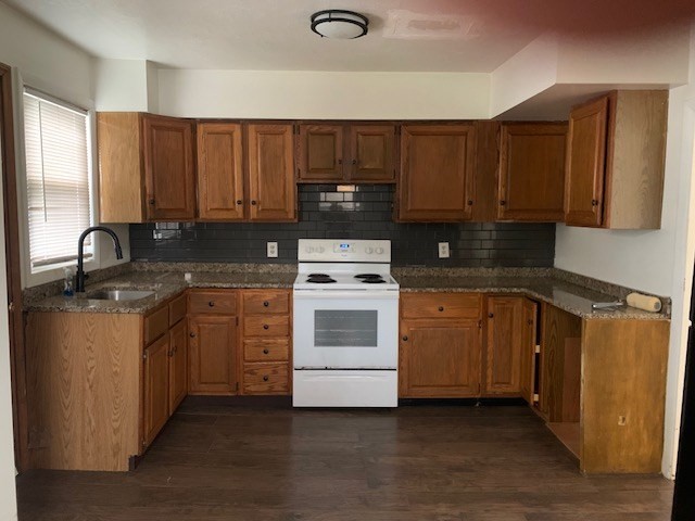 2284 Cranberry Highway Wareham, MA 02576 - Photo 2 of 12 a kitchen with a sink stove and cabinets
