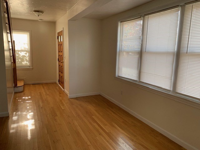 2284 Cranberry Highway Wareham, MA 02576 - Photo 5 of 12 a view of an empty room with wooden floor and a window
