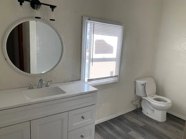 a bathroom with a toilet sink and mirror
