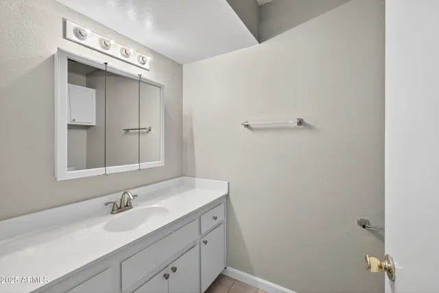 a bathroom with a sink a vanity and a mirror