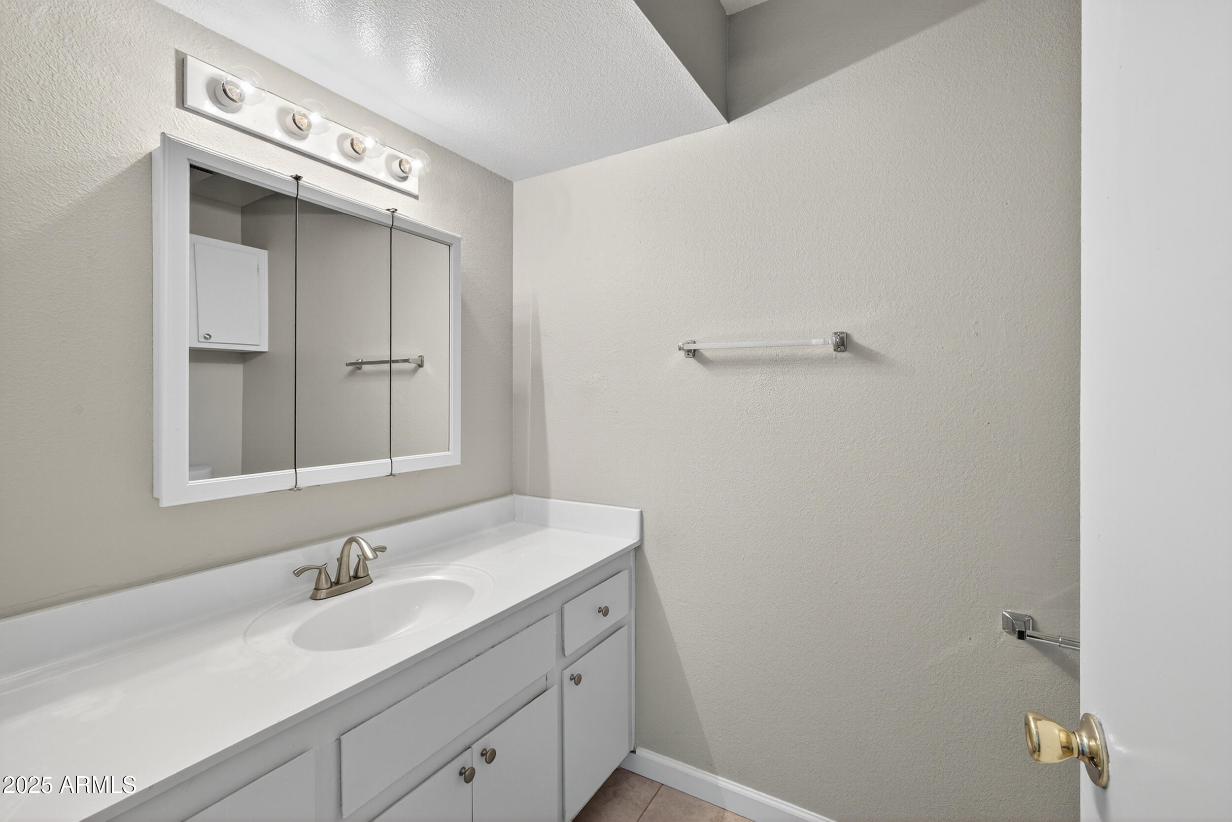 860 East Brown Road, Unit 67 Mesa, AZ 85203 - Photo 13 of 27 a bathroom with a sink a vanity and a mirror