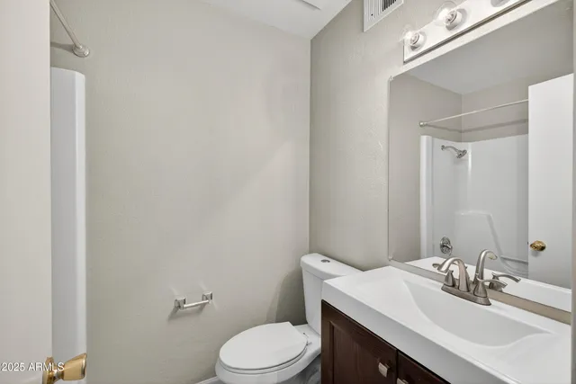a bathroom with a sink a toilet and mirror