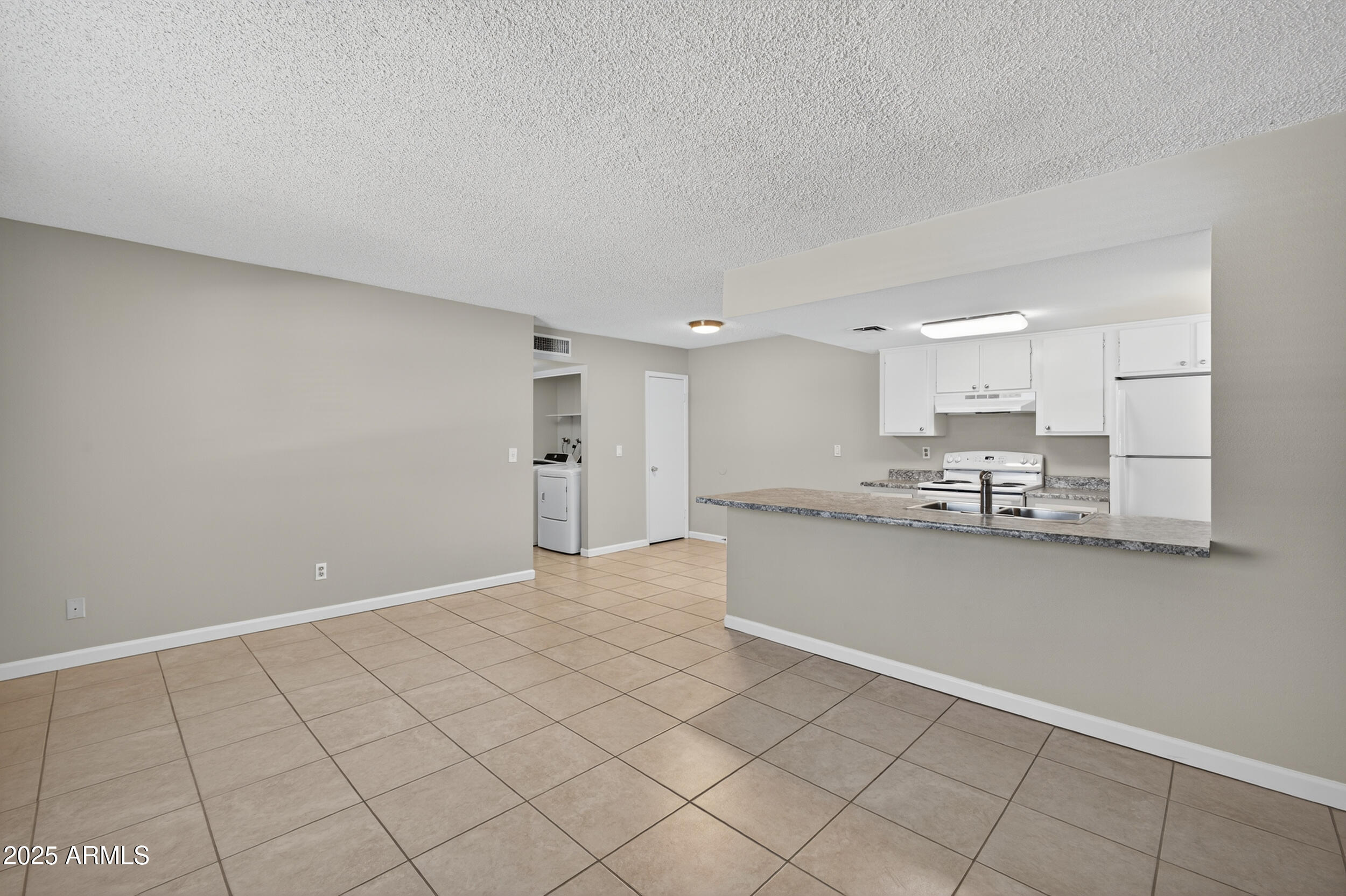 860 East Brown Road, Unit 67 Mesa, AZ 85203 - Photo 6 of 27 a large white kitchen with cabinets