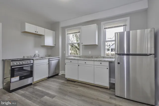 a kitchen with a sink stove and refrigerator