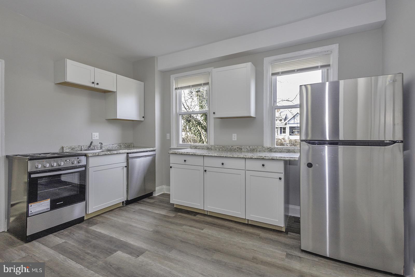 3407 Elgin Avenue, Unit 1 Baltimore, MD 21216 - Photo 8 of 15 a kitchen with a sink stove and refrigerator