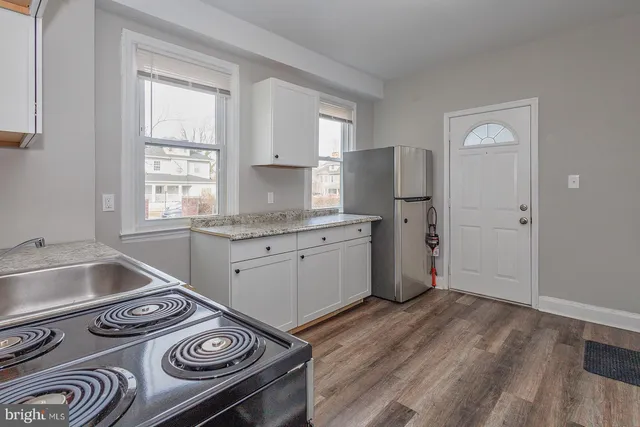 a kitchen that has a sink and a stove