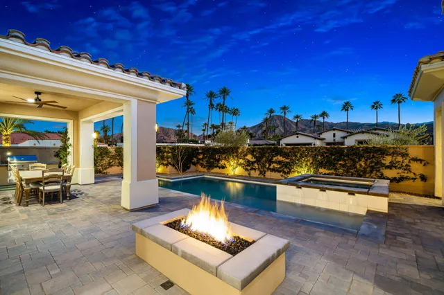 a living room with couch chairs and a fireplace