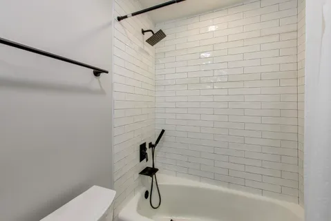 a white toilet sitting next to a bathroom sink