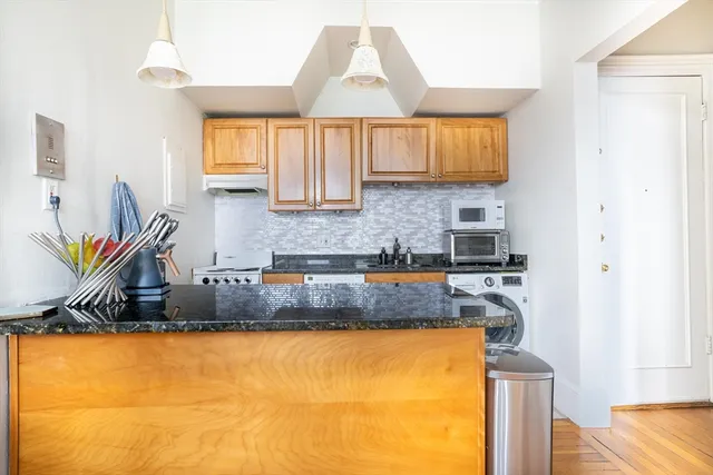 a kitchen with stainless steel appliances granite countertop a sink and a granite counter tops