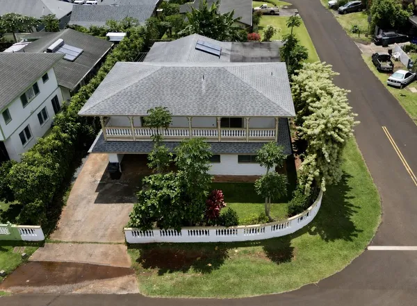 an aerial view of a house with swimming pool and garden