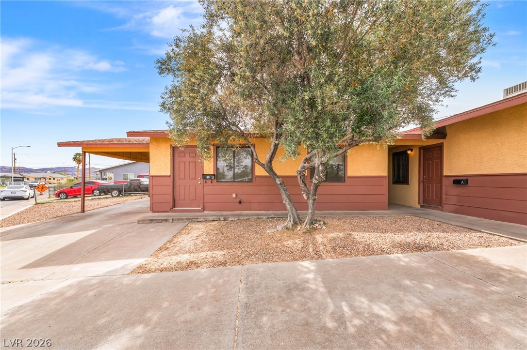 242 Nebraska Avenue Henderson, NV 89015 - Photo 32 of 46 Unit B featuring an attached carport, driveway, and stucco siding