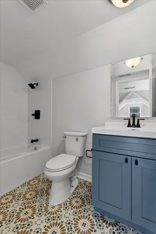 a bathroom with a sink toilet vanity and shower