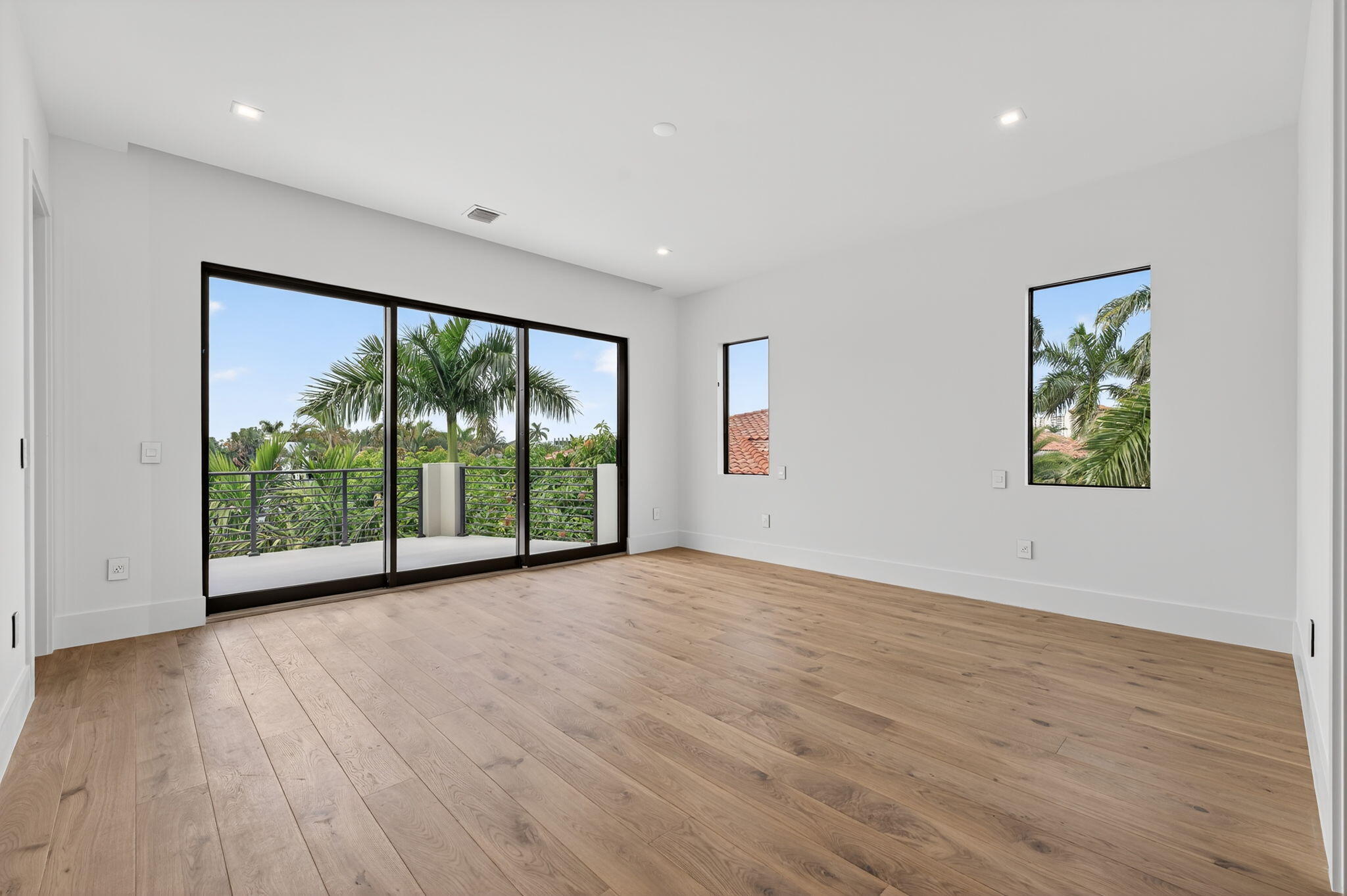 721 Northeast 34th Street Boca Raton, FL 33431 - Photo 56 of 76 a view of an empty room with a window and wooden floor