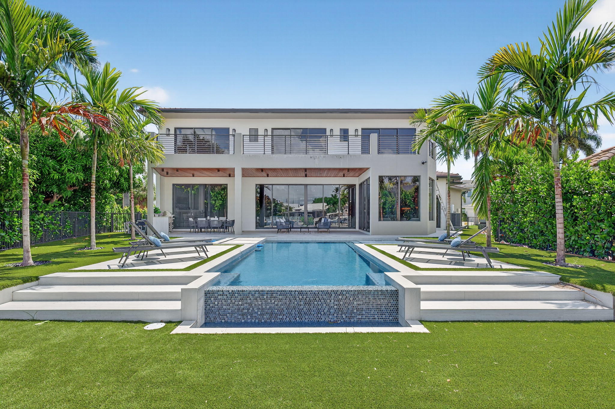 721 Northeast 34th Street Boca Raton, FL 33431 - Photo 66 of 76 a view of swimming pool with palm trees and a yard