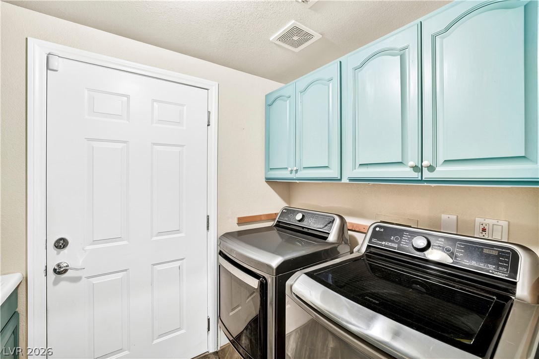 1135 Calico Ridge Drive Henderson, NV 89011 - Photo 29 of 86 Functional utility room featuring integrated storage and contemporary appliances.