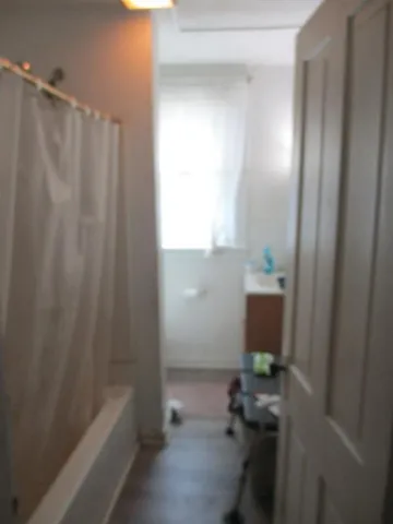 a bathroom with a bathtub and shower