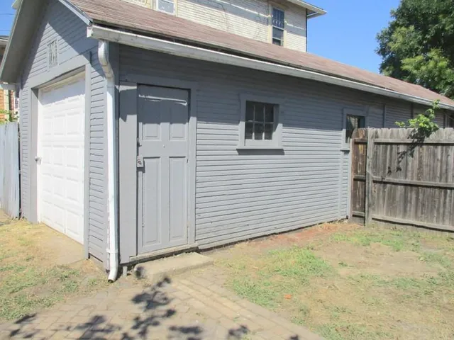 a view of a house with a wooden fence