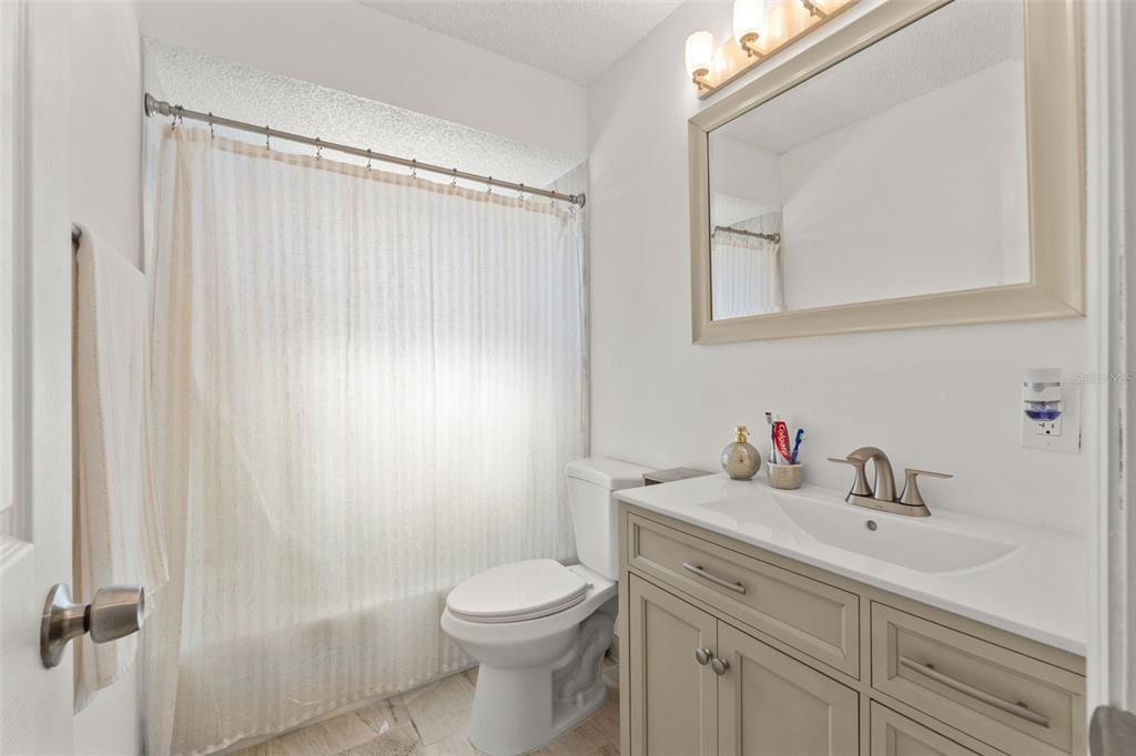 8306 Needles Drive Hudson, FL 34667 - Photo 18 of 39 a bathroom with a sink a toilet and a mirror
