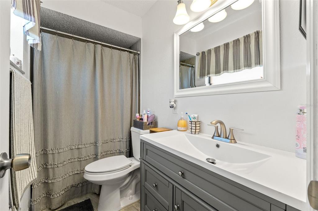 8306 Needles Drive Hudson, FL 34667 - Photo 23 of 39 a bathroom with a sink a toilet and shower