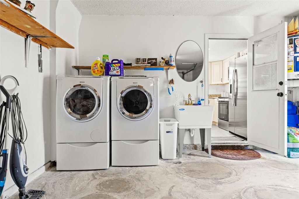 8306 Needles Drive Hudson, FL 34667 - Photo 34 of 39 a view of a storage & utility room with washer and dryer