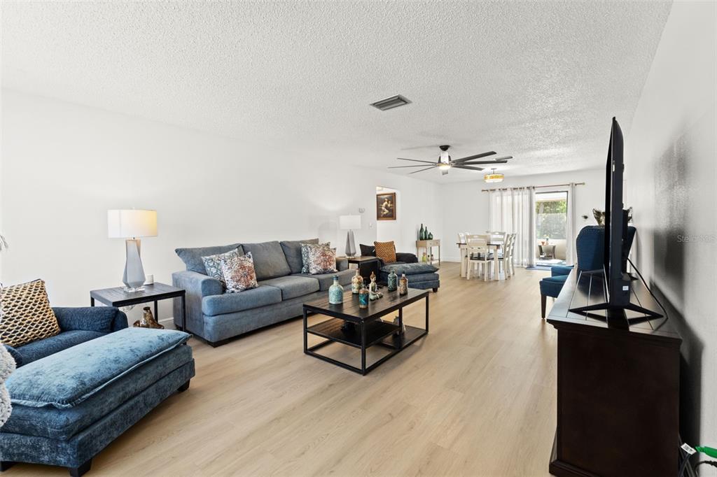 8306 Needles Drive Hudson, FL 34667 - Photo 5 of 39 a living room with furniture window and a flat screen tv