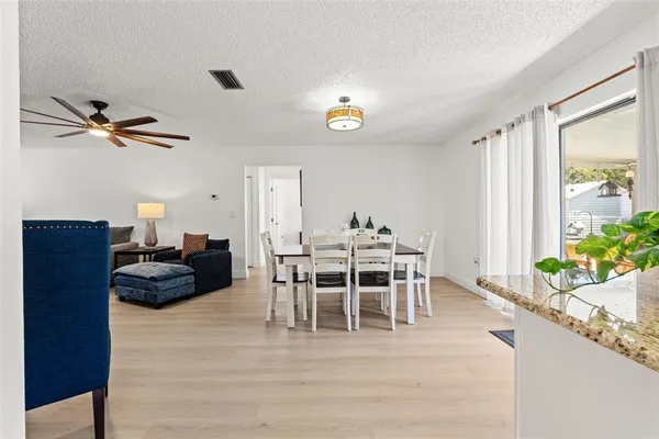 a dining room with furniture and wooden floor
