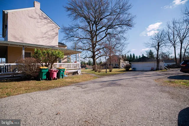 a view of road with card parked on the roadside