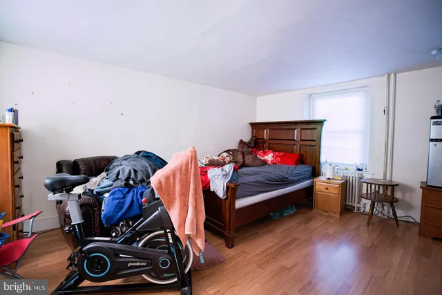 a bedroom with furniture and a wooden floor