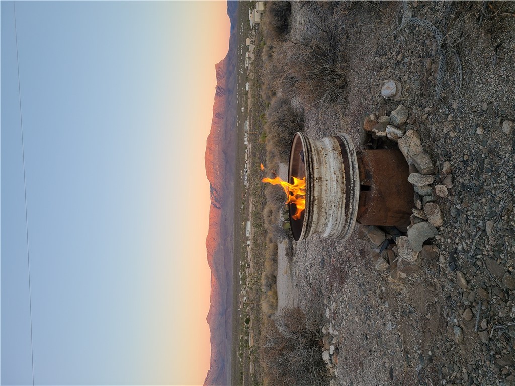 27071 Rainbow Road Meadview, AZ 86444 - Photo 10 of 11 Yard at dusk featuring a fire pit and a mountain view