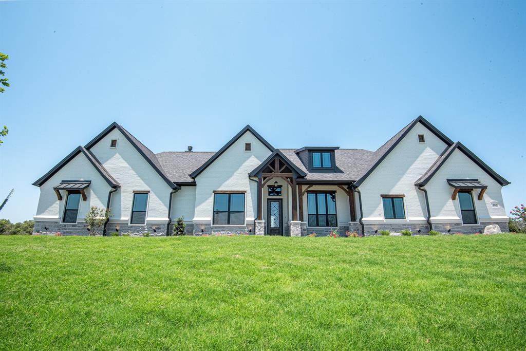 a front view of house with yard and green space
