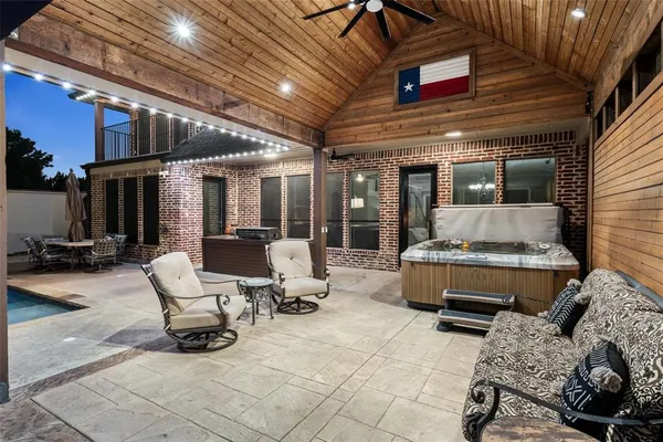 a building outdoor space with patio furniture and potted plants