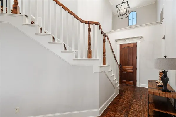 a view of entryway and hall with wooden floor