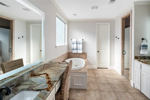 a spacious bathroom with a granite countertop sink and a mirror