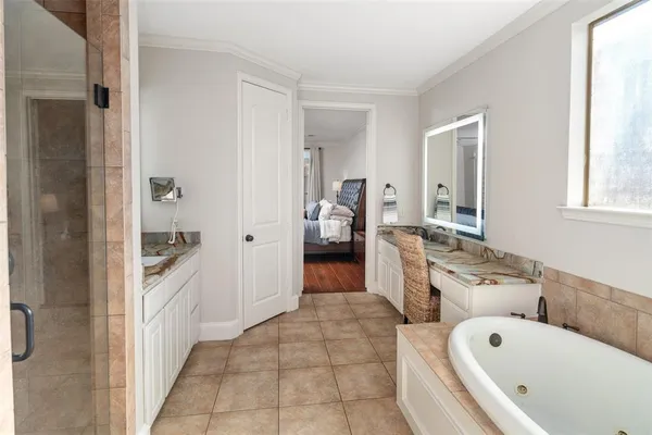 a bathroom with a tub sink and mirror