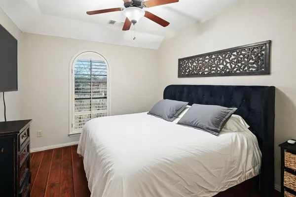 a bedroom with a large bed and a window