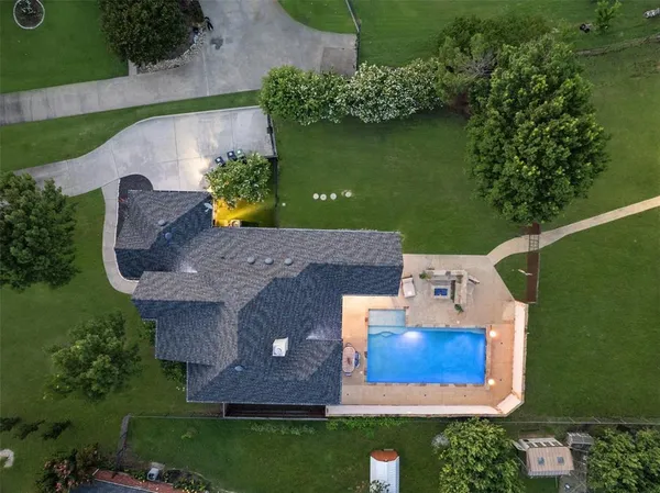an aerial view of a house with a yard basket ball court and outdoor seating