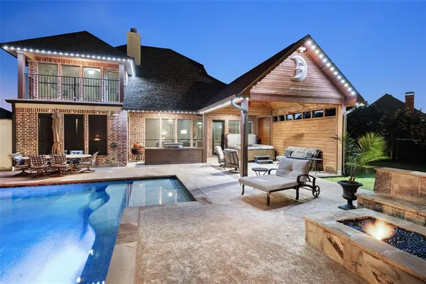 a view of a house with swimming pool and sitting area