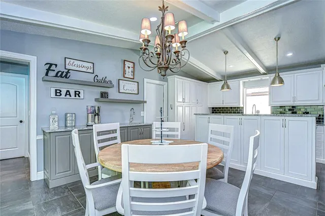 a dining room with furniture a large window and wooden floor