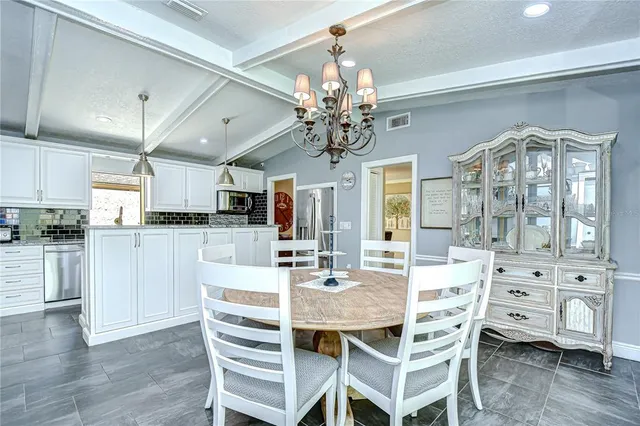 a view of a dining room with furniture wooden floor and chandelier